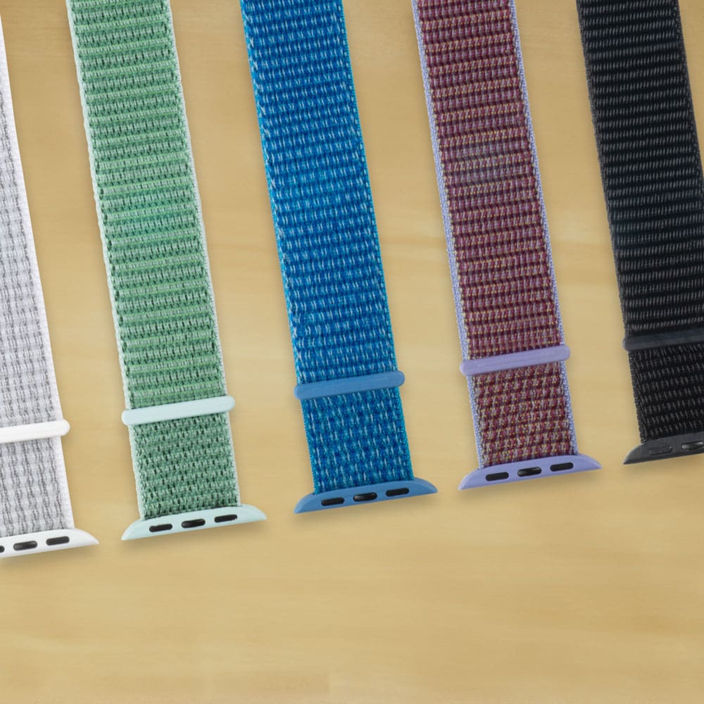 Five Bi-Tapp Bands flat on desk white, green, blue, purple and black.